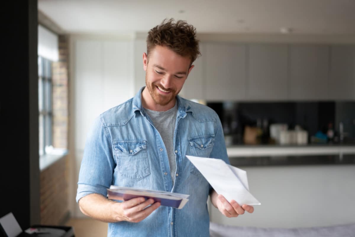direct mail man at home checking mail