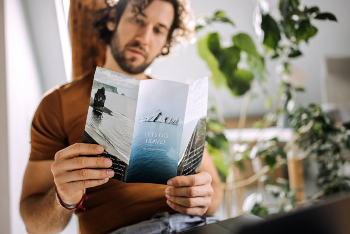 marketing collateral man viewing brochure